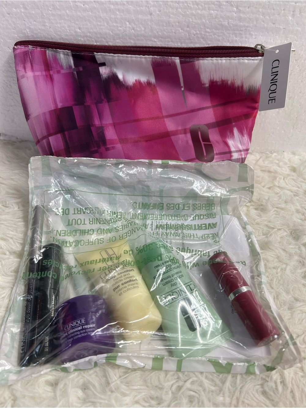 Clinique Pink Patterned Cosmetic Pouch with Assorted Travel Skincare